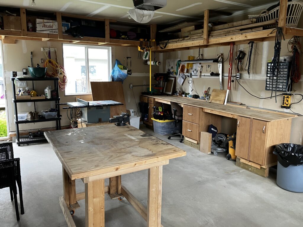 A garage with work benches and various power tools