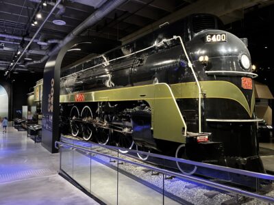 An old fashioned but sleek steam locomotive in a museum.